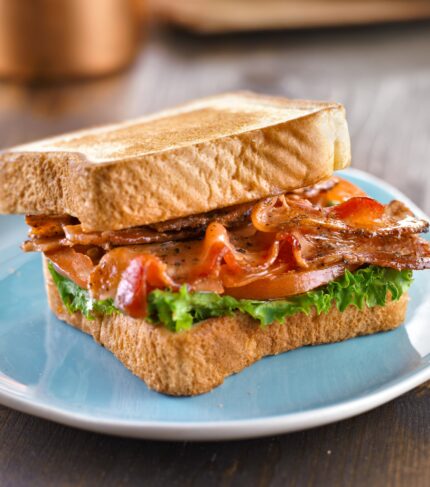 BLT bacon lettuce tomato sandwich with toast off to the side.