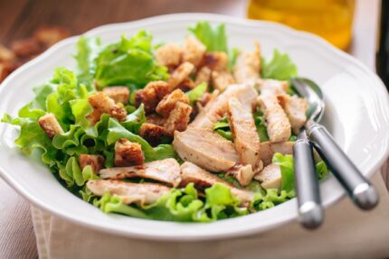 Caesar Salad with grilled chicken and croutons.